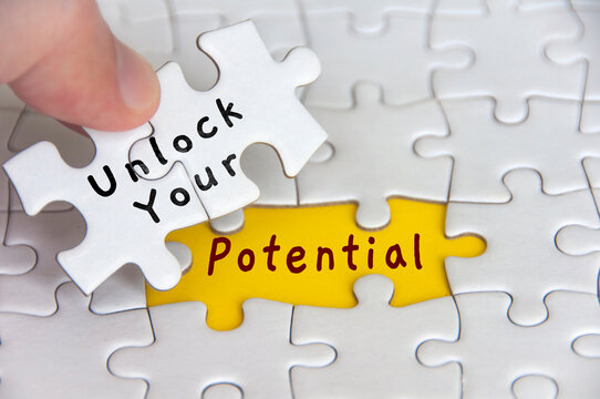 Unlock your potential text on jigsaw puzzle. Motivational and inspirational concept