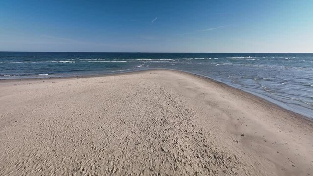 Aerial footage of tip of Skagens Gren (the northermost tip of the Jutland penisula) where the Baltic Sea and the North Sea meet. Point where the Kattegat and Skagerrak Seas meet, creating waves.
