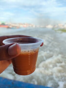 A hand holding a cup of tea