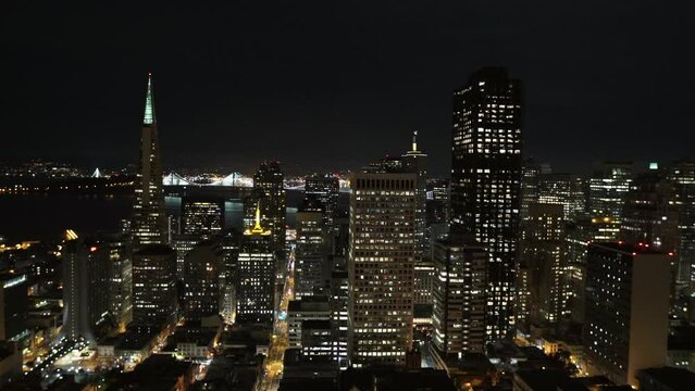 Aerial Lockdown Shot Of Illuminated Skyscrapers In City Against Sky At Night - San Francisco, California
