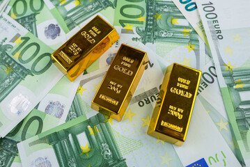 Euro banknotes and gold bars.