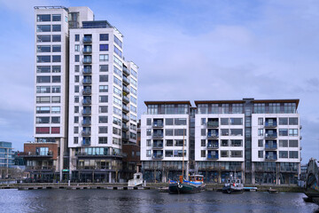Row of modern apartment buildings in the Docklands area of Dublin along the Grand Canal