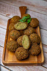 Falafel balls on a wooden cutting board and tahini sauce, High quality photo