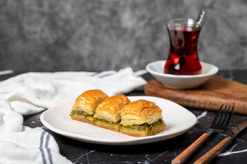 Pistachio baklava. Pistachio baklava with syrup on a dark background. Turkish cuisine delicacies