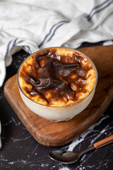 Rice pudding on a dark background. Rice pudding dessert made with milk. Turkish cuisine delicacies. Local name sütlaç. Close up