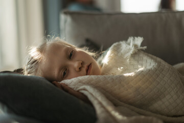 LIttle sick girl lying and sleeping in her bed.