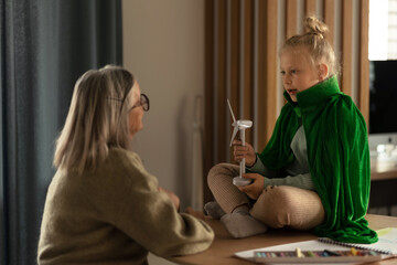 Senior woman doing homework with her granddaughter.