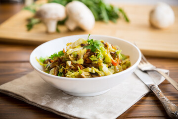 cabbage early fried with mushrooms, carrots and vegetables