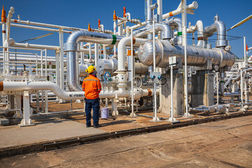 Male worker inspection at the exchanger of tank oil refinery pipeline plant steam vessel and column...