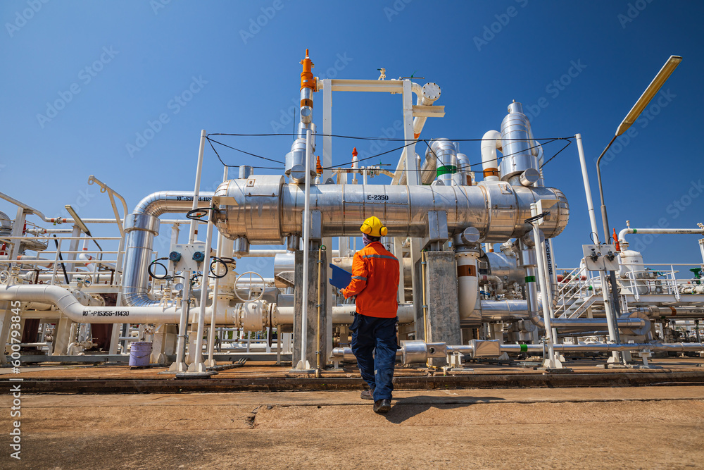 Wall mural male worker inspection at the exchanger of tank oil refinery pipeline plant steam vessel and column  - Wall murals