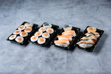 A view of several sushi rolls and nigiri pieces.