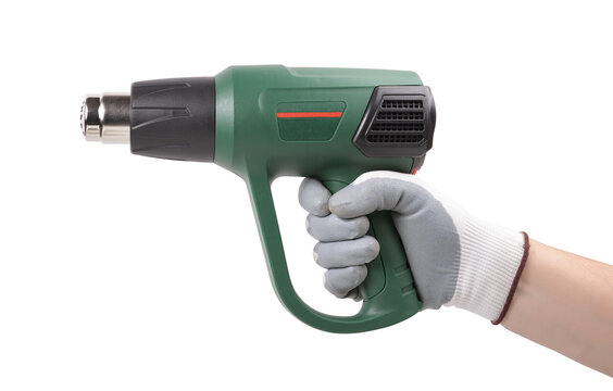 Worker's hand holding a construction hair dryer insulated on white background. Construction tools.