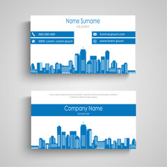 Business card with city silhouette in blue design