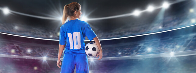 Portrait of young female soccer player standing with back with soccer ball standing on isolated...