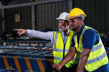 Plant manager visit engineer in factory at production line discuss on quality assurance improvement