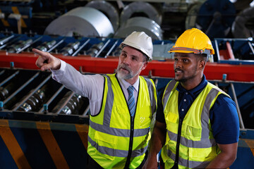 Plant manager visit engineer in factory at production line discuss on quality assurance improvement