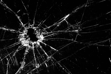 broken glass - cracked with hole over black