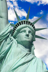 Fototapeta premium Close-up of the Statue of Liberty with blue sky