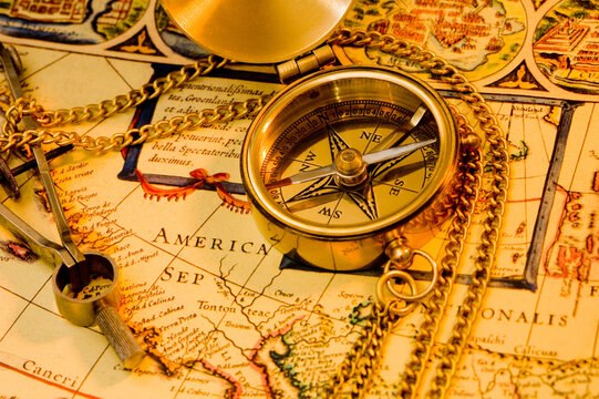 Old style brass compass on antique  map
