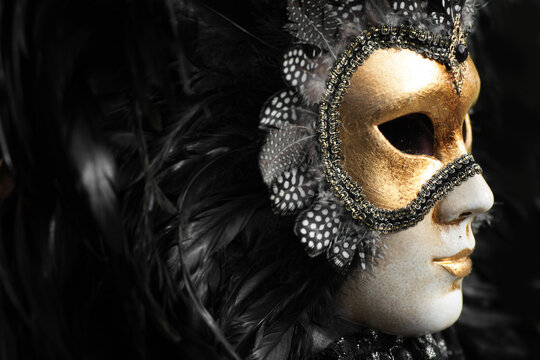 Venetian mask decorated with gold leaf and embedded with fowl feathers.