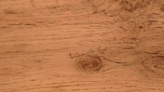 Flat wooden board surface tracking. Wood texture. Wooden vintage natural background. Abstract background of wooden floor. Moving. Top view. Close-up. Camera movement. Wood pattern texture.