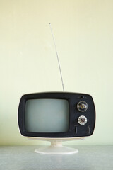 Still life of vintage television set with antenna raised.
