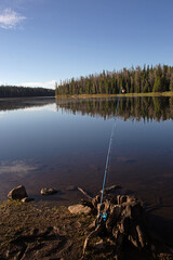 Fishing pole with a clear mountain lake 