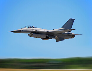 Fototapeta na wymiar Military jet flying at hogh speed with motion blur