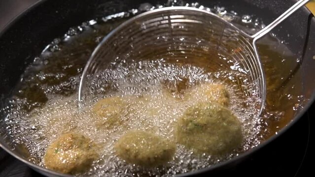 Ramadan Delights, Hummus Falafel, Middle Eastern Culture. Falafel balls frying, Open Fire Cooking, Deep fried street food, High quality 4k footage