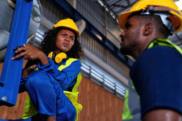 Female and male engineer in factory production line discuss and repair broken machine