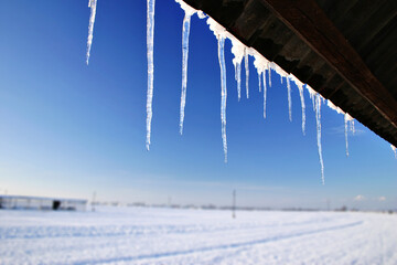 Icicles hanging fom roof in winter