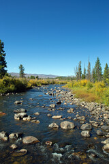 Mountain stream with clear blue skies in the background pure clean fresh water 