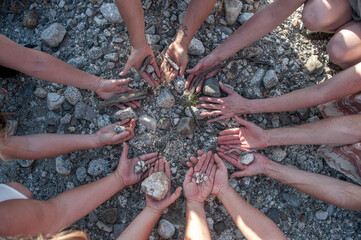 Women's hands in a circle on the earth. 