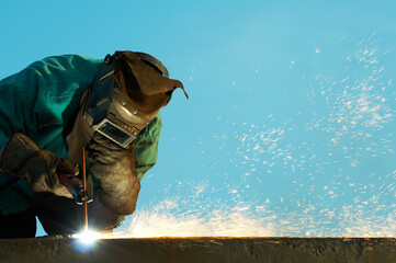 welder at shipyard working - obrazy, fototapety, plakaty