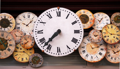 Several antique clock faces of different sizes and styles