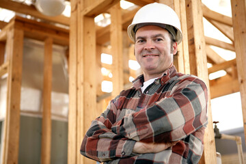 A handsome, friendly construction worker on the job site.  Authentic construction worker on actual...