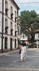 Fototapeta na wymiar A girl walking down the street in Santiago de Compostela