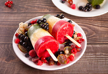 Homemade tasty vegan berries ice cream layered colorful popsicles. Summer dessert