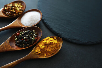 Wooden spoons with spices. A mixture of peppers and spices. Fragrant herbs for food.