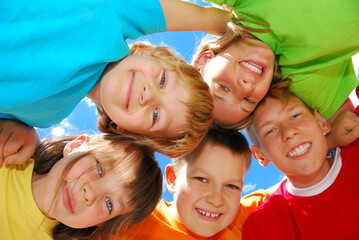 Happy kids forming a huddle.