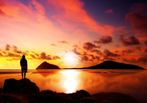 Silhouette of man reflecting while looking at a gorgeous sunset