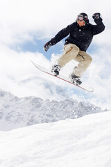 Fototapeta na wymiar snowboarder taking jump in fresh fallen snow