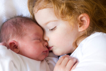 little girl with her newborn sister, only a couple of hours old