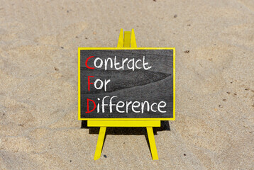 CFD symbol. Concept words CFD contract of difference on beautiful black chalk blackboard. Beautiful sand beach background. Business and CFD contract of difference concept. Copy space.