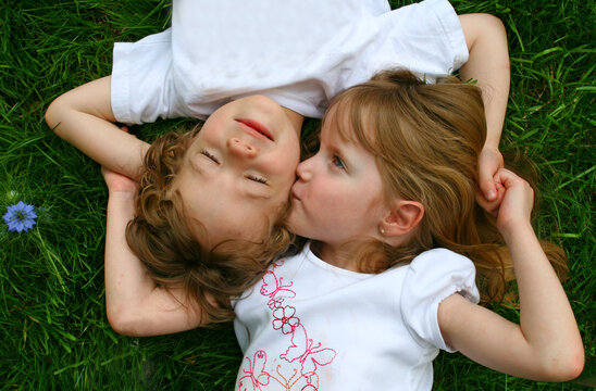 A set of boy/girl twins playing in the grass