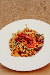 A plate of fresh homemade Italian pasta with typical Mediterranean sauces and seafood
