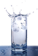 Splashing ice cubes in the glass full of water