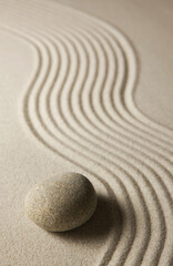 Fototapeta na wymiar Stone on raked sand. Zen concept.