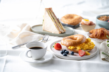 Breakfast eggs berries and strawberry fruit on a white plate