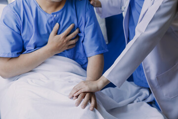 doctor check up after surgery. doctor touching patient hand and consoling.